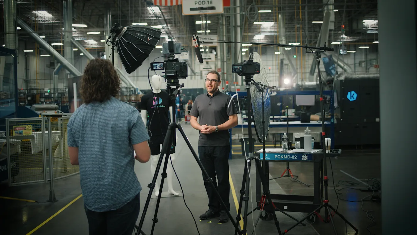 A multi-camera interview setup on a production floor